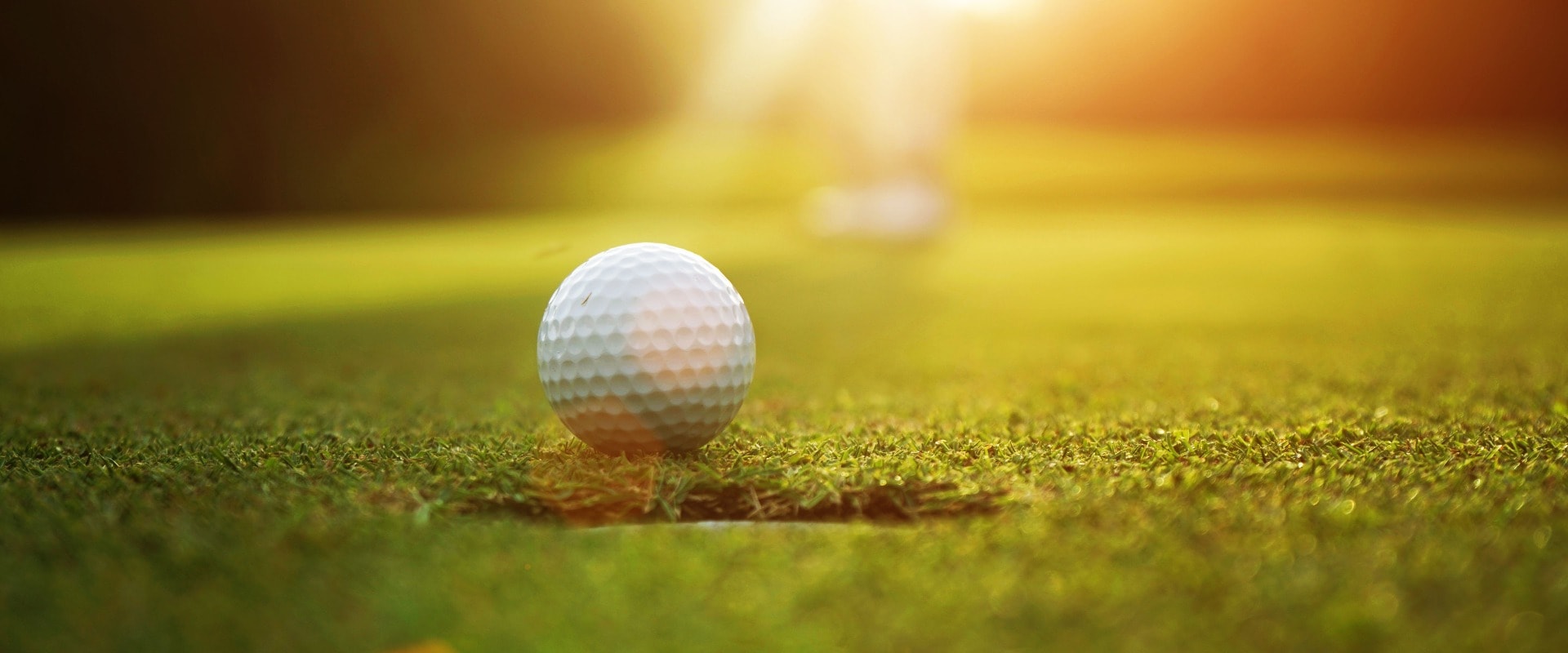 Blurred golfers are putting golf in the evening golf course golf backglound in Thailand